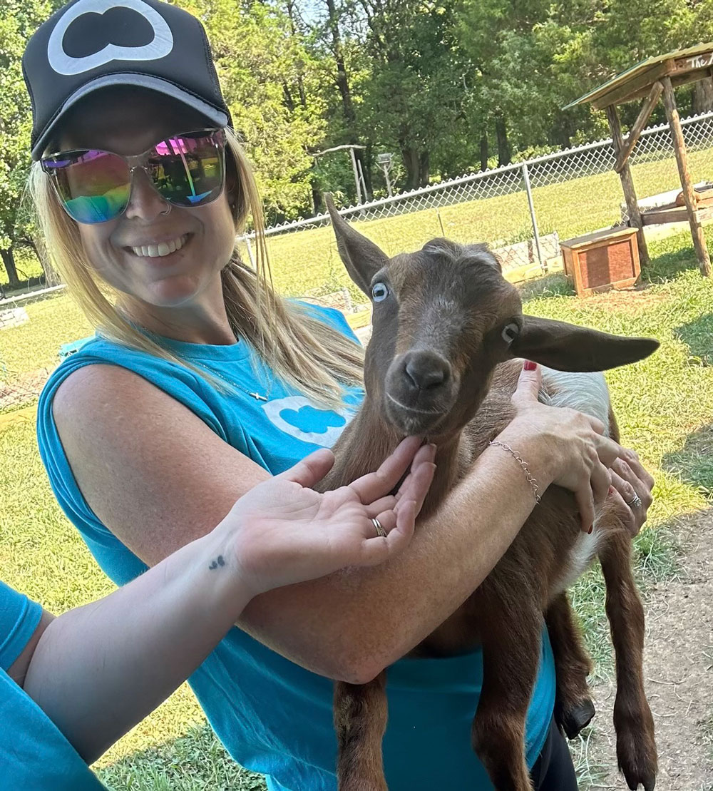 woman holding therapy goat